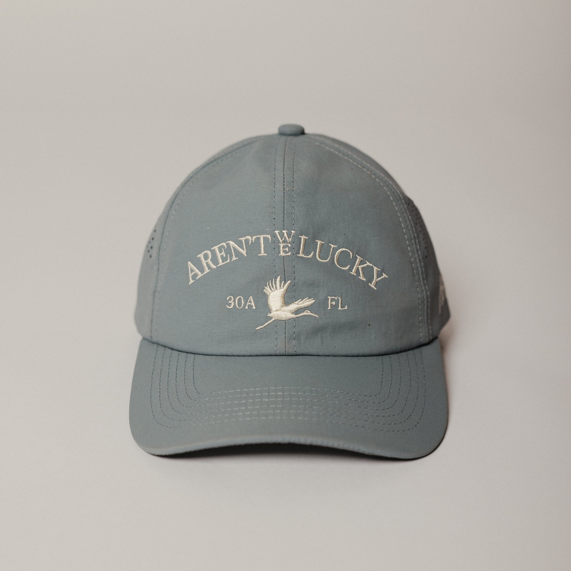Gray cap with text and logo on a light gray background